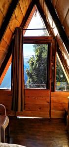 a room with a large window in a cabin at Glamping Jaulares Mountain in Rivas
