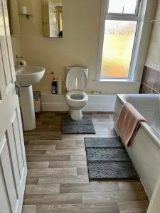 a bathroom with a toilet and a sink at Victorian house between cathedral, river and station in Ely