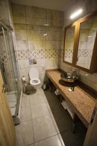 a bathroom with a toilet and a sink and a shower at TUNA OTEL in Gelibolu