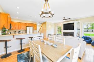 a kitchen and dining room with a wooden table at The Tides --- 19989 Sandy Bottom Unit 701 in Rehoboth Beach