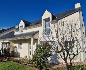 a white house with a black roof at Chambre et sdb privées avec accès indépendant et autonome in Saint-Herblain