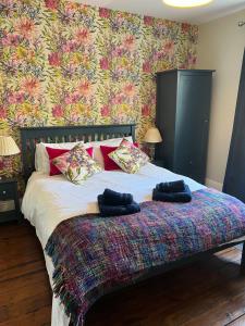 a bedroom with a bed with two pillows on it at Horse Market Cottage Kirkby Lonsdale in Kirkby Lonsdale