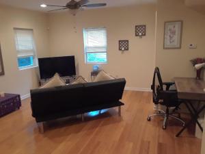 a living room with a couch and a table at Lovely 1-Bedroom/Near FedEx Field/Close to DC 