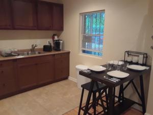 a kitchen with a table with chairs and a sink at Lovely 1-Bedroom/Near FedEx Field/Close to DC 
