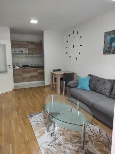 a living room with a couch and a table at Apartman MD in Lukavica