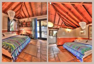 1 dormitorio con 2 camas y techo de madera en Finca Cebollino, en La Orotava