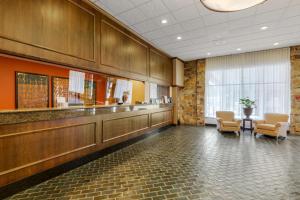 a waiting room with two chairs and a table at Best Western Plus Wooster Hotel & Conference Center in Wooster