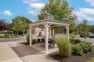 a gazebo with a table and chairs on a sidewalk at Best Western Plus Wooster Hotel & Conference Center in Wooster