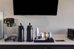 a counter top with a coffee maker and other items at Motel 6 Branson West, MO - Silver Dollar City in Branson West