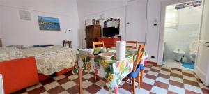 sypialnia ze stołem oraz łazienka z toaletą w obiekcie Bed & Breakfast Porta d'Oriente w mieście Brindisi