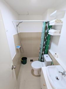 a bathroom with a toilet and a sink at Close to Polymedic Medical Plaza with FREE Wi-fi & Netflix in Cagayan de Oro