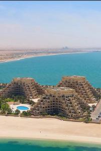 an aerial view of a resort on the beach at Rixos Beach Apartment in Ras al Khaimah