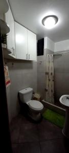a small bathroom with a toilet and a sink at Departamento Jesus Maria in Lima