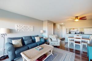 a living room with a blue couch and a table at Great Lakes 5 in Glen Arbor