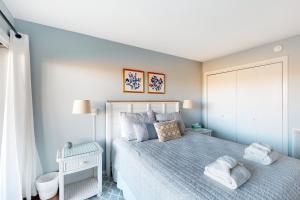 a bedroom with a bed with towels on it at Great Lakes 5 in Glen Arbor
