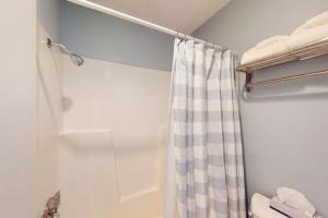 a bathroom with a shower with a shower curtain at Great Lakes 5 in Glen Arbor +10 photos