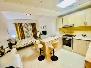 a kitchen with a table and chairs in a room at Rixos Beach Apartment in Ras al Khaimah