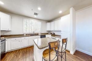 a kitchen with white cabinets and a counter top at Paradise Valley Vacation Home in Phoenix