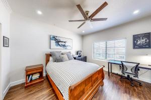 a bedroom with a bed and a desk and a ceiling fan at Paradise Valley Vacation Home in Phoenix