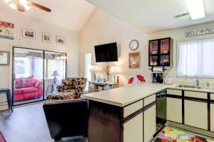 a kitchen with a counter top and a living room at Fairway Village - B6 in Myrtle Beach