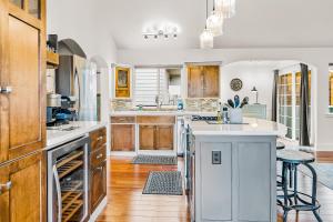 a kitchen with wooden cabinets and a white counter top at Jewel by the Sea in Cambria