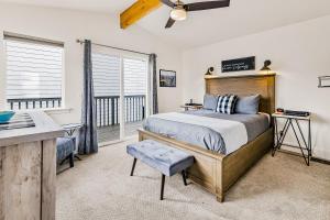 a bedroom with a bed and a desk and a window at Jewel by the Sea in Cambria