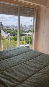 1 dormitorio con cama y ventana grande en Hermoso 2 ambientes en Palermo Hollywood en Buenos Aires