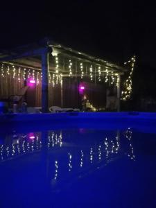 a house with christmas lights and a swimming pool at Hostal Namaste in Salta