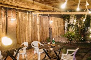 a patio with a table and chairs and lights at Hostal Namaste in Salta