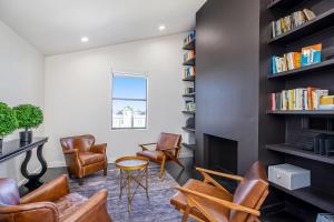 a living room with leather chairs and a fireplace at Skyline Loft in Houston