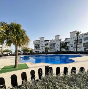 a large swimming pool in front of some buildings at Apartment in Hacienda Riquelme Golf Resort in Sucina