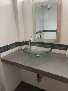 a bathroom with a sink and a mirror at Exclusivo Apartamento en el Centro Histórico Trujillo - 3er Piso in Trujillo