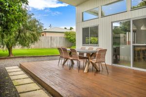 a patio with a table and chairs on a deck at Central Park in Port Fairy