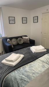 a bed with two white towels on top of it at Bv Homely Studio Fifteen At Deighton Huddersfield in Huddersfield