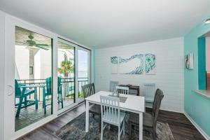 a dining room with a table and chairs at La Puerta Island Retreat with Florida Flair in St Petersburg
