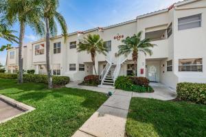a building with palm trees in front of it at Vista Verde E Beautifully Updated, Contemporary Condo in St Petersburg