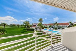 a view of the pool from the balcony of a resort at Vista Verde E Beautifully Updated, Contemporary Condo in St Petersburg