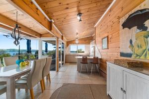 a kitchen and dining room with a table and chairs at Barne the Bentley - Taupo Holiday Home in Taupo