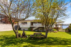 a backyard with a picnic table and two trees at Barne the Bentley - Taupo Holiday Home in Taupo