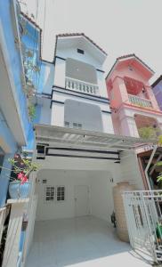 a white building with a garage in the middle at Bangkok Private 4Bedrooms-Parking-Weekly Special Offer in Bangkok