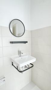 a white bathroom with a sink and a mirror at Bangkok Private 4Bedrooms-Parking-Weekly Special Offer in Bangkok