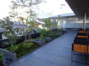 a courtyard with trees and plants on a building at Tokyu Stay Kyoto Sakaiza Shijo Kawaramachi in Kyoto