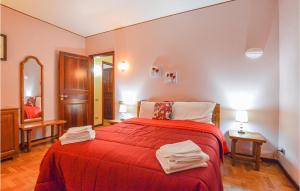 Un dormitorio con una cama roja con toallas. en Amazing Home In Menfi With Kitchen en Menfi