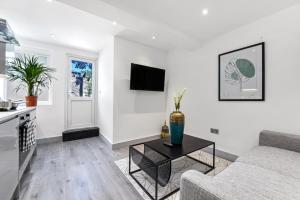a living room with a couch and a table at Lovely 2 Bedroom Apartment in Greater London in London