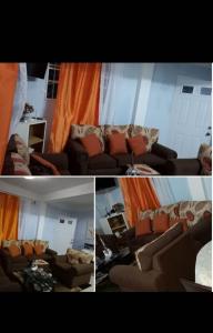 a living room with brown couches and an orange curtain at Comfort Haven in Roseau