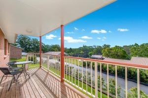 a balcony with a table and chairs and a view at H1111 Mission Terrace Lakewood Heights Estate in Laurieton