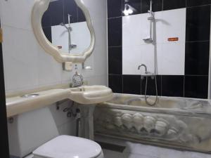 a bathroom with a sink and a bath tub at Diamond Motel in Sacheon