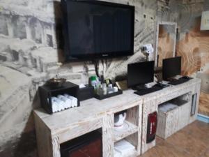 a entertainment center with a flat screen tv on top at Diamond Motel in Sacheon