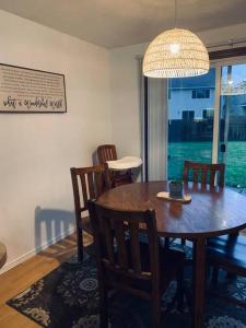 a dining room with a table and chairs and a chandelier at Hathaway a family home in Corvallis