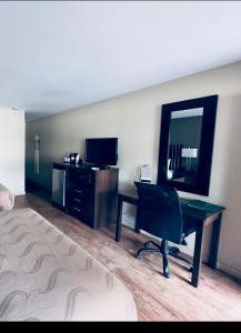 a hotel room with a desk and a mirror at Quality Inn Durango in Durango